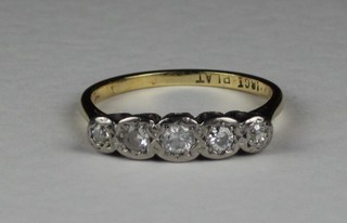 An 18ct gold dress ring set 5 illusion set diamonds