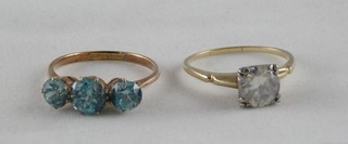 A "gold" dress ring set 3 blue zircons and 1 other set a white stone