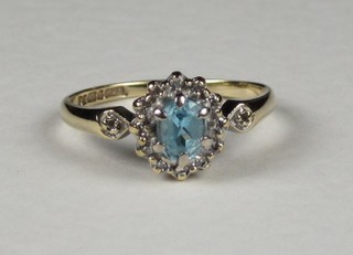 A 9ct gold yellow gold dress ring set an aquamarine supported by diamonds
