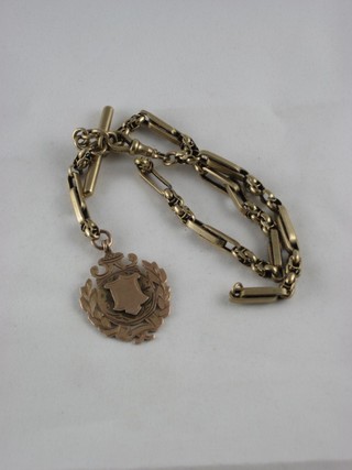 A hollow 9ct gold fetter link double Albert watch chain hung a gold medallion