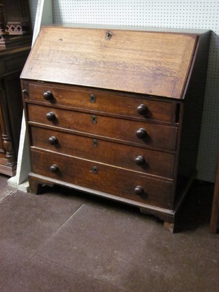 A 19th Century oak bureau, the fall front revealing a well fitted interior above 4 long drawers with tore handles, raised on bracket feet 39"