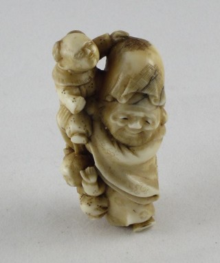 A reproduction Netsuke of a man and child 2"