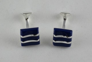 A pair of silver and lapis lazuli T shaped cufflinks