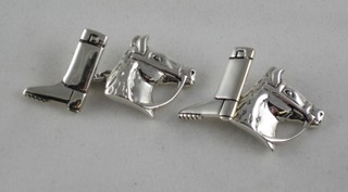 A pair of silver cufflinks in the form of a horses head and riding boots