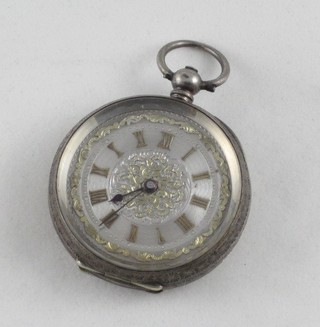 A lady's open faced fob watch contained in a silver Continental case
