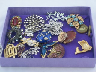 A box containing various costume jewellery  brooches