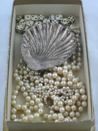 3 strings of simulated pearl beads, a collection of die and a silver plated scallop shaped butter dish