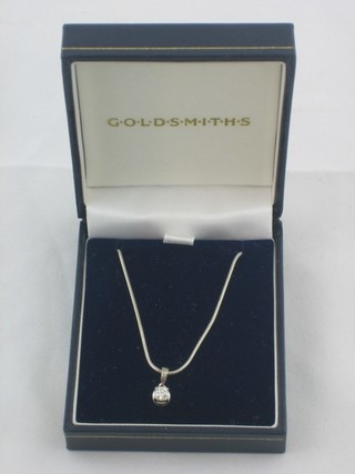 A diamond pendant hung on a fine 18ct gold chain