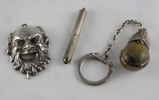 A silver cased tooth pick, a pendant in the form of a theatrical mask and a hardstone key ring
