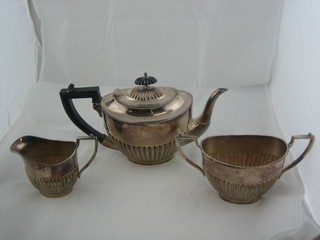 An oval 3 piece Britannia metal tea service with demi-reeded decoration - teapot, twin handled sugar bowl and cream jug