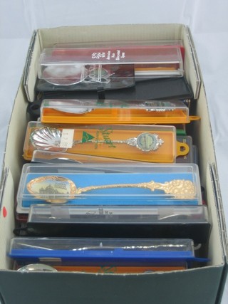 A collection of various souvenir teaspoons