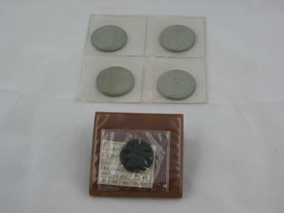 A Roman coin together with 4 Portuguese coins