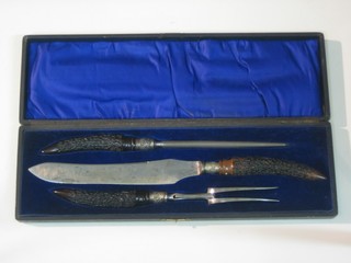 A 3 piece Victorian carving set by Mulberry Cutlers Co. with stag horn handles, comprising carving knife, fork and steel, cased