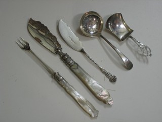 A Victorian silver butter knife with mother of pearl handle, do. pickle fork with  mother of pearl handle, a silver caddy spoon and a silver sifter spoon