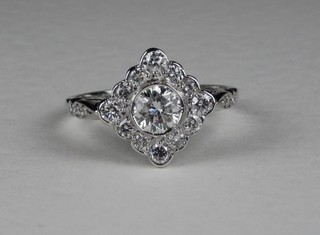 A lady's 18ct white gold Art Deco style dress ring, set a diamond surrounded by diamonds