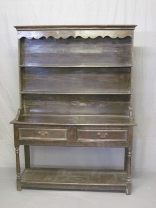 An 18th Century oak dresser with raised back fitted 2 shelves, the base fitted 2 drawers above a cupboard, raised on turned and block supports 51" 