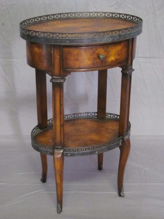 A 20th Century French oval walnut 2 tier bedside cabinet with pierced gilt mounts, raised on cabriole supports 17"