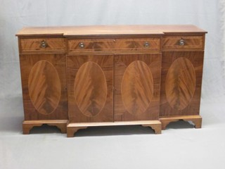 A Georgian style mahogany breakfront sideboard with crossbanded dop fitted 1 long drawer above a double cupboard, flanked by a pair of cupboards and raised on bracket feet 60"