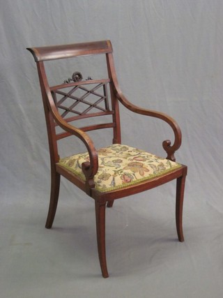 An Edwardian Empire style inlaid mahogany open arm bar back chair with pierced panel to the back and upholstered seat, raised on splayed supports