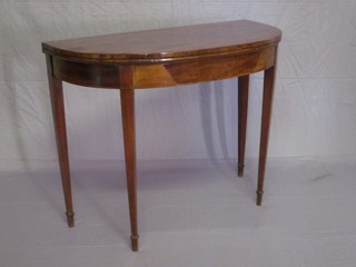 A Georgian mahogany demi-lune card table, raised on square tapering supports ending in spade feet 37"