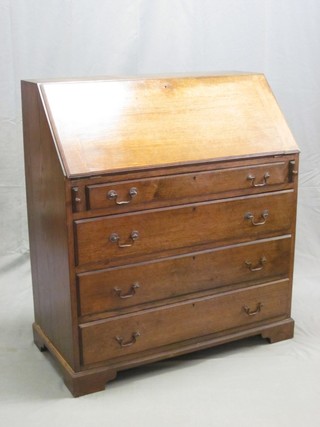 An oak bureau with fall front revealing a well fitted interior above 4 long graduated drawers, raised on bracket feet 36"