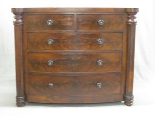 A Victorian mahogany bow front chest of 2 short and 3 long drawers with tore handles and columns to the sides 52"
