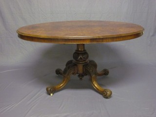A Victorian oval figured walnut snap top Loo table, raised on turned column and tripod base 53" (some damage to rim)