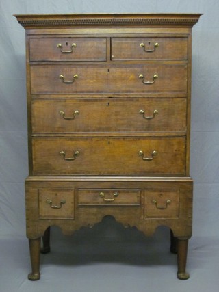 An 18th Century oak chest on stand with moulded and dentil cornice, the upper section fitted 2 short drawers above 3 long drawers, the base fitted 1 long drawer flanked by 2 short drawers with brass swan neck drop handles, raised on club supports 40" ILLU