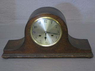 A chiming mantel clock with silvered dial and Arabic numerals contained in an oak Admiral's hat shaped case