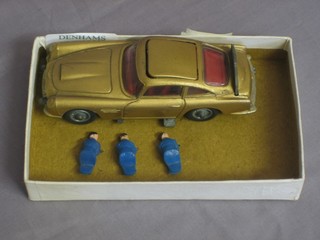 A Corgi James Bond gold painted Aston Martin DB5 containing 2 figures and 3 other figures