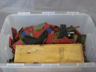 A plastic crate containing a collection of Meccano
