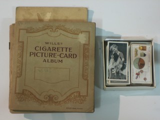 A collection of loose cigarette cards and a Players album of cigarette cards and 4 Wills albums of cigarette cards