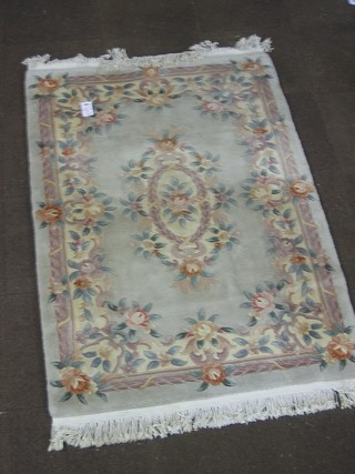 A Chinese peach ground and floral patterned rug 72" x 48"