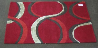 A contemporary red ground wool rug 71" x 48"