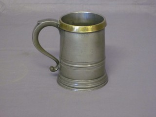A Victorian pewter quart tankard with brass rim by G David 551 Old Kent Road, London