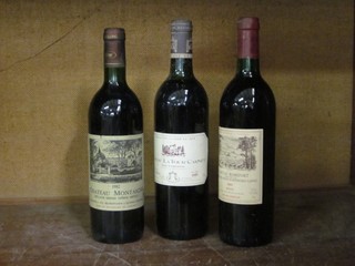 A bottle of 1982 Chateau Montaigne, a bottle of 1985 Chateau La Tour Carnet and a bottle of 1989 Chateau Romefort