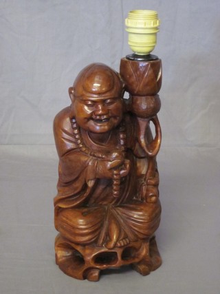 A carved root wood figure in the form of a standing sage, converted for use as a table lamp 11"