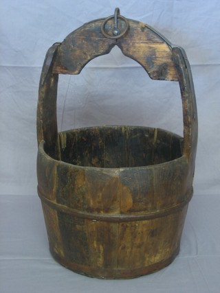 A circular Eastern wooden well bucket