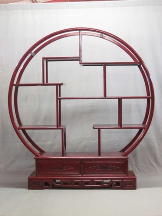 A circular shaped Oriental hardwood display stand, the base fitted a drawer 60"