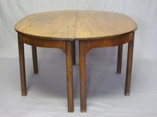 A Georgian mahogany demi-lune dining table, raised on 8 squared supports 53"