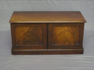 A 19th Century rectangular walnut cabinet enclosed by panelled doors, raised on a platform base 30"