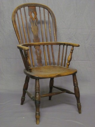 An 18th/19th Century elm stick and bar back kitchen carver chair with H framed stretcher (f and r)