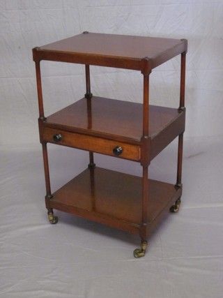 A Victorian rectangular mahogany 2 tier what-not fitted a drawer and raised on turned supports with brass caps and castors 18"