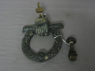 A Victorian iron door knocker in the form of a hand with wreath 6"