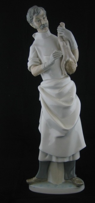 A Lladro figure of a standing male mid wife 14 1/2"