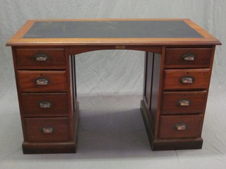 An Edwardian walnut kneehole pedestal desk with inset writing surface above 8 short drawers 48"