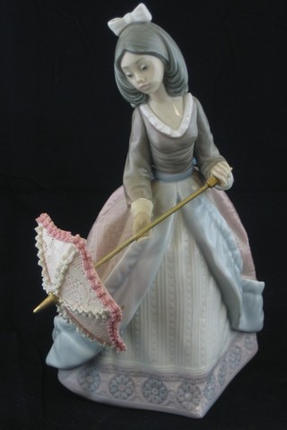 A Lladro figure of a standing lady with parasol, the base marked 5210 7"