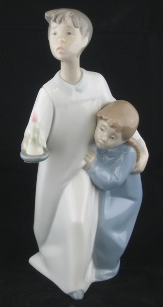 A Lladro figure of boy and girl with night gowns and chamber stick 8", base incised MY30H