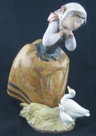 A Lladro figure of a girl with pitch fork, musing on 2 ducks, the base marked Lladro 1278 9"