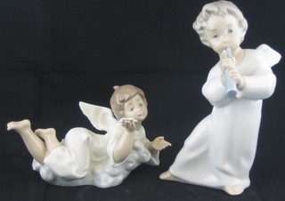 A Lladro figure of a standing Angel Boy with musical instrument 6" and 1 other of a reclining Angel child with star 3"